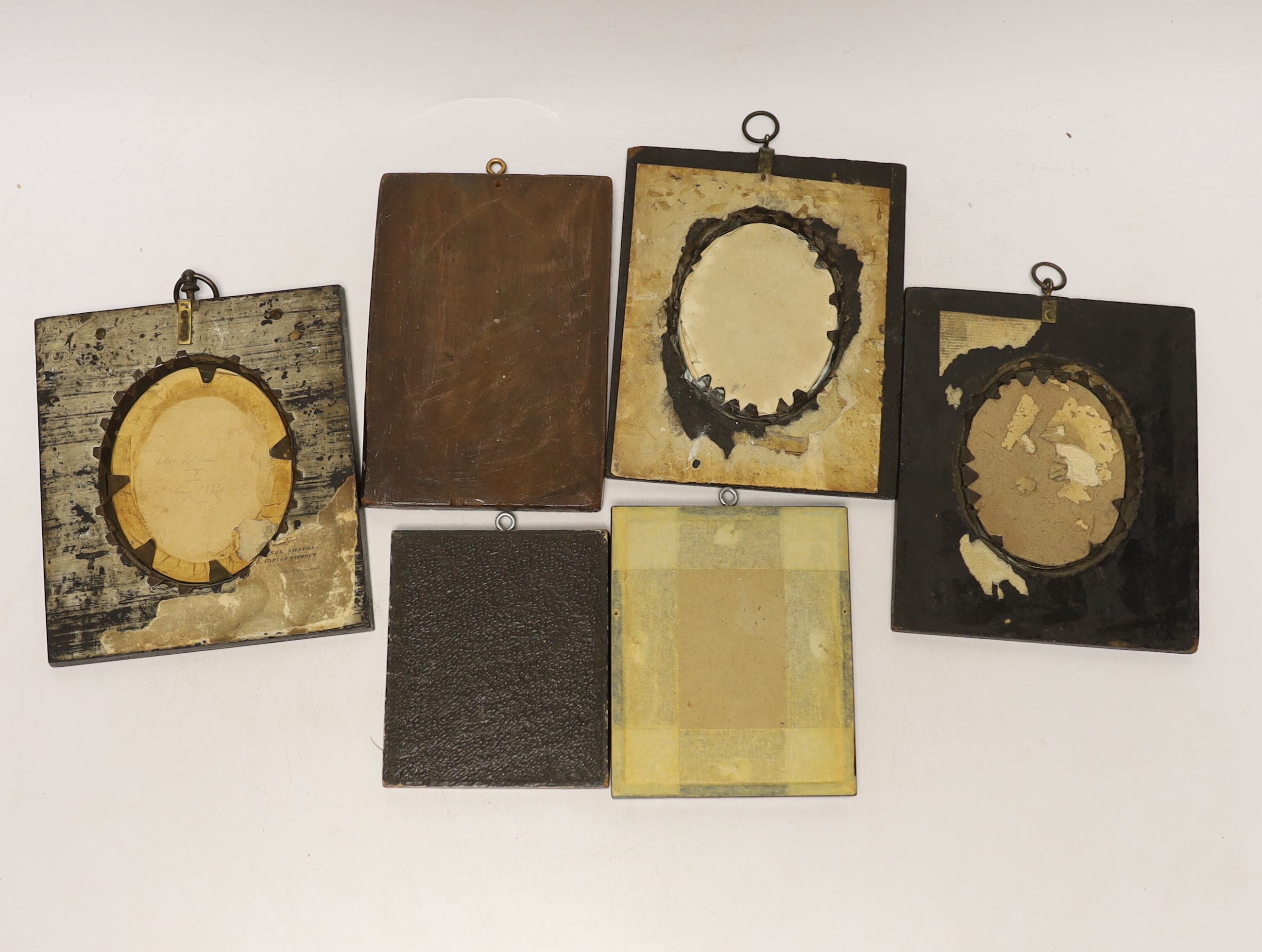 A quantity of miniatures comprising oil of an 18th century gentleman wearing a wig, three 19th century silhouettes, Victorian blue and white photograph and one other